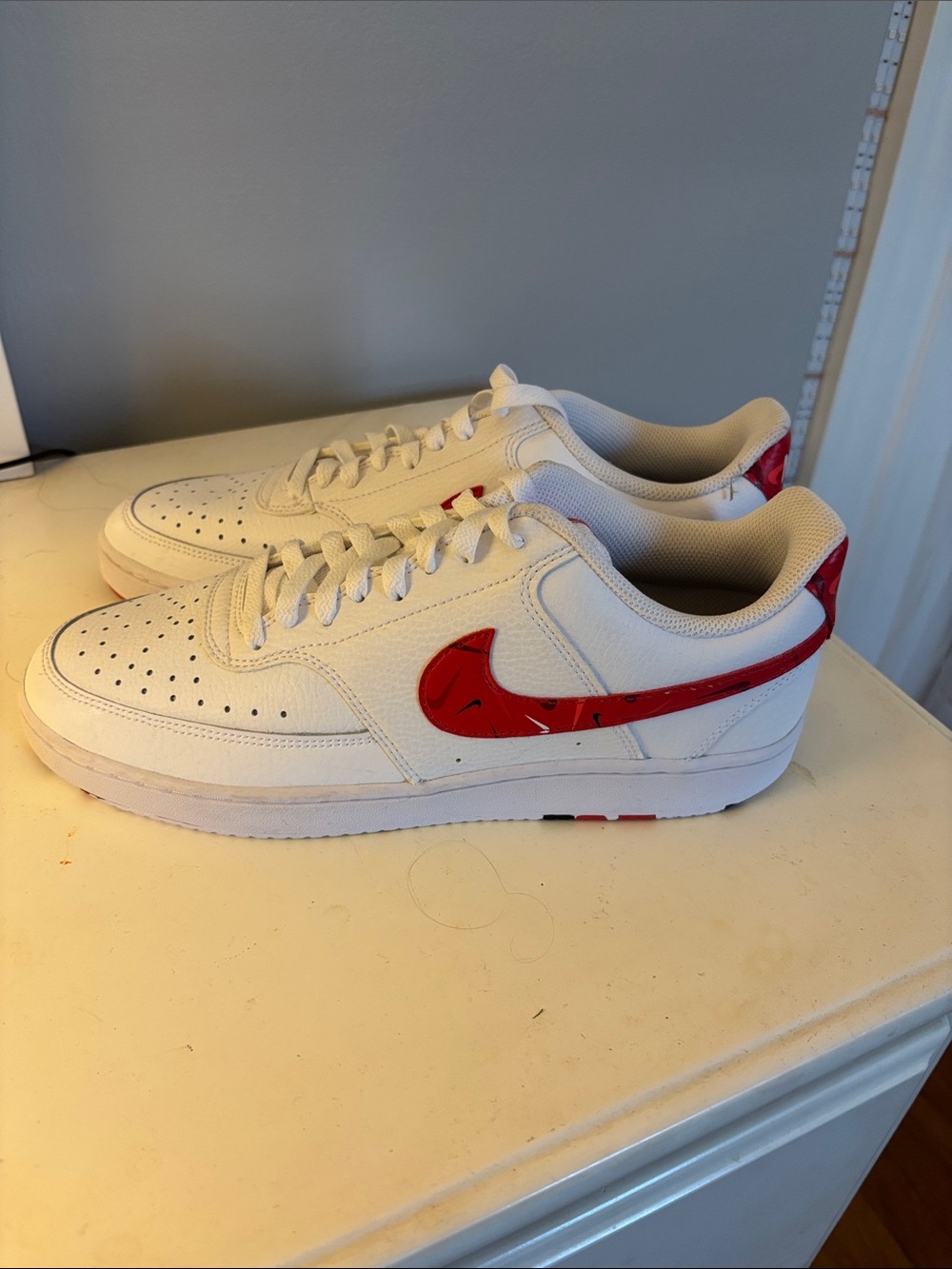 Nike Men’s White Sneakers with Red Swoosh Accent